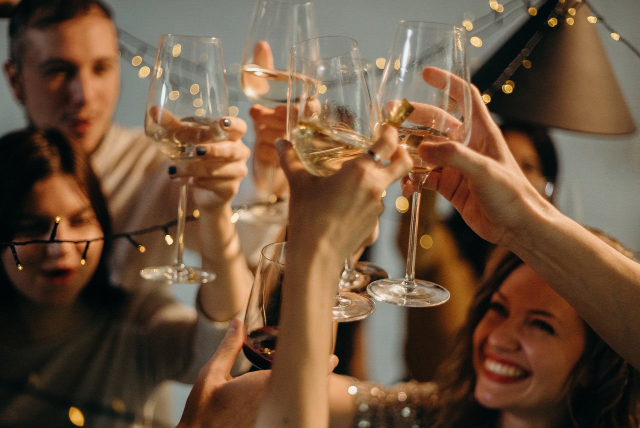 Group of people touching wine glasses.